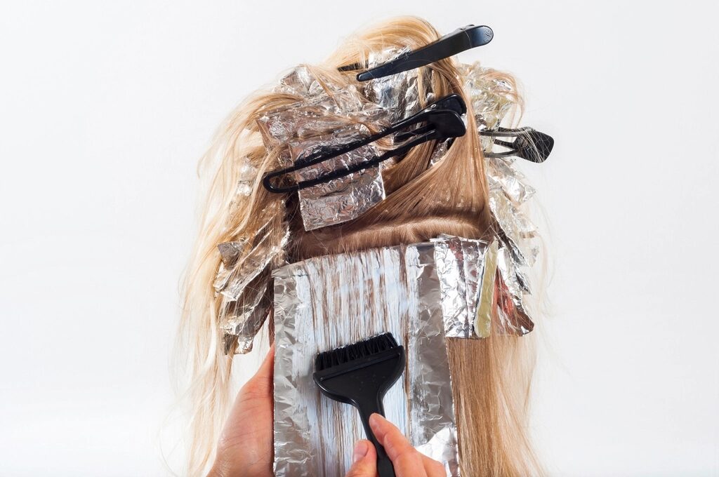 Foils being painted into long blonde hair