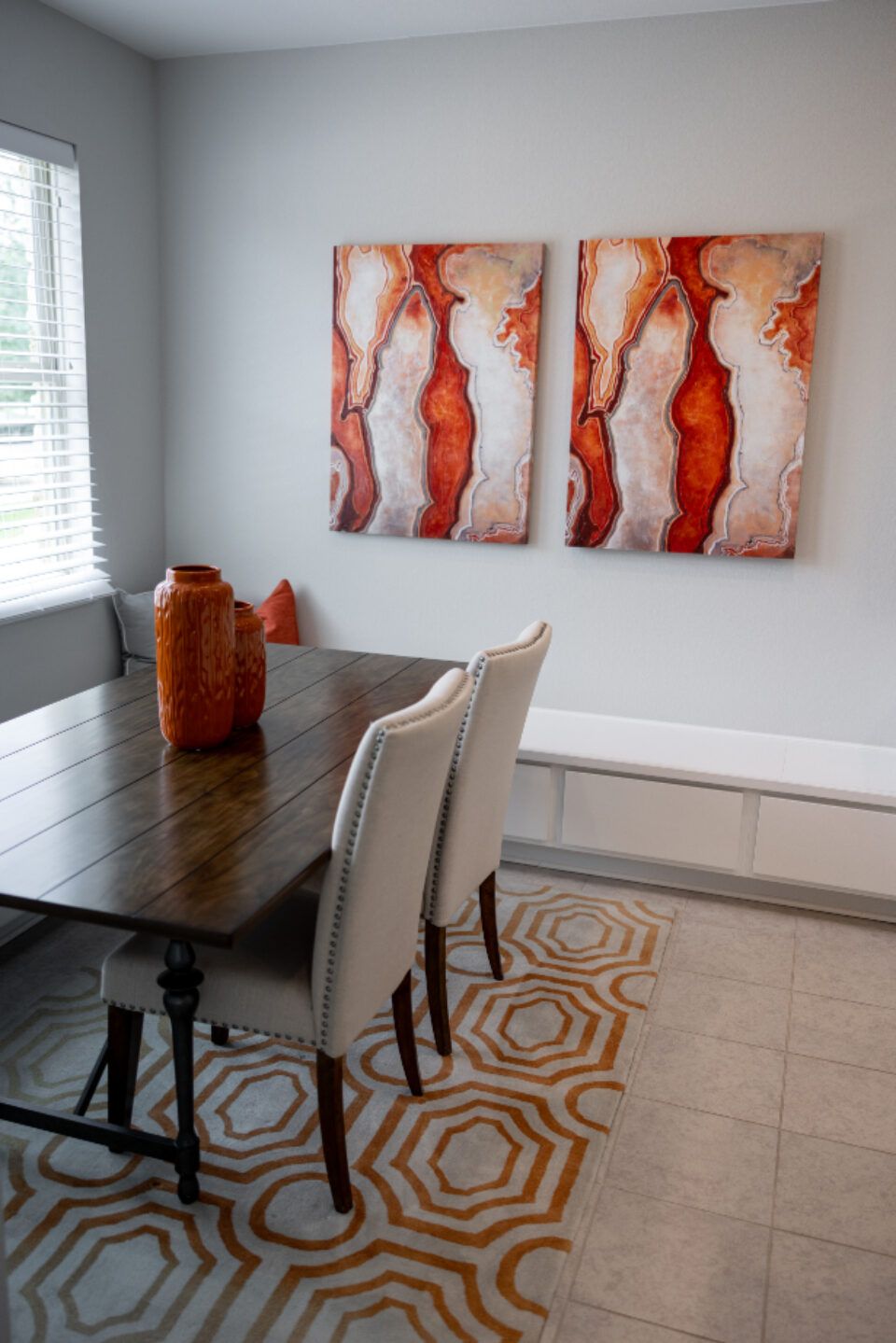 Dining table and chairs against a white wall