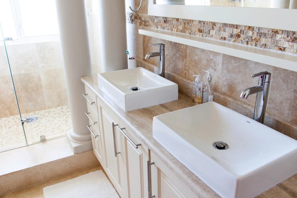 Two square bathroom basins with chrome taps