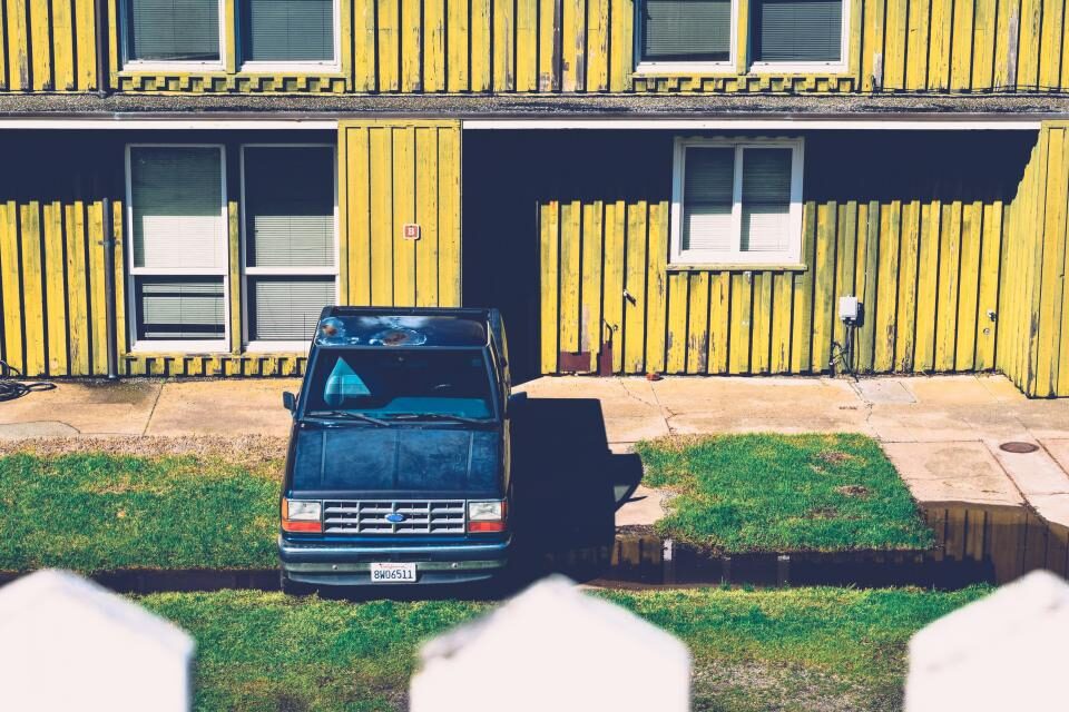 Painted siding and a paved driveway with a parked truck