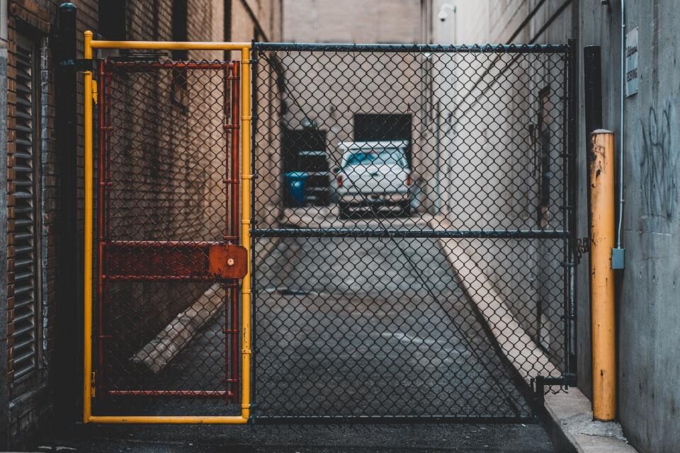 Concrete service lane behind a metal gate